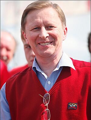 Sergei Ivanov, smiling, in red vest