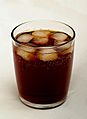 Tumbler of cola with ice