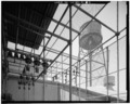 VIEW OF WATER TOWER FROM ELECTRICAL TRANSFORMER CAGE AT NORTH END OF SECOND FLOOR WAREHOUSE. VIEW TO WEST-NORTHWEST. - Ford Motor Company Long Beach Assembly Plant, Assembly HAER CAL,19-LONGB,2-A-4