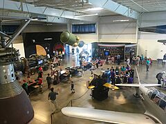 Visitors inside the Exhibit Hall at the Aerospace Museum of California near the space exhibits