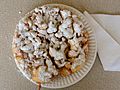 A funnel cake on a paper plate.jpg
