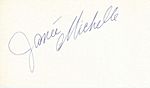 The handwritten name "Janée Michelle" in grey slanted from the bottom left to the top right all on a white background with the "M" curled under the first name