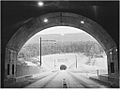 Black-and-white photo of second tunnel seen from end of the first