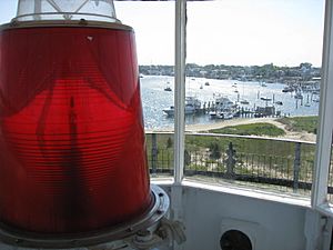 Edgartown Lighthouse lens, with Edgartown Harbor in the distance