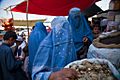 Burqa clad women bying at a market