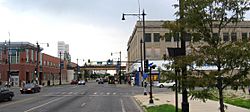 The intersection of 63rd and Halsted, looking south. The Halsted 'L' station can be seen crossing Halsted in the distance. Kennedy–King College occupies the buildings on the left of the photo. The building on the right burned in 2014.