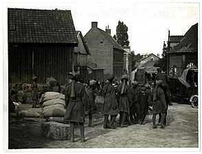 Indian Cavy. Regt. unloading supplies of hay & oats from supply column motor lorry (Estrée Blanche, France). Photographer- H. D. Girdwood. (13873925093)