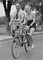 Man and woman on a Malvern Star abreast tandem bicycle, c. 1930s, by Sam Hood
