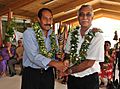 The Premier of Niue, Hon. Toke Talag hands over the Queen's Baton Delhi 2010 to the Associate Minister Of Sports Hon. Dalton Tagelagi, in Niue on May 12, 2010