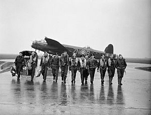 Aircrew of No. 106 Squadron photographed in front of a Lancaster at Syerston, Nottinghamshire, on the morning after the raids on Genoa, 22-23 October 1942. CH17504