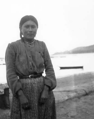 Hoh woman named Minnie Cole poses outside near water, Hoh Indian Reservation, Washington, 1905.png