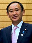 Yoshihide Suga cropped 3 Joint Press Announcement of the Okinawa Consolidation Plan.jpg