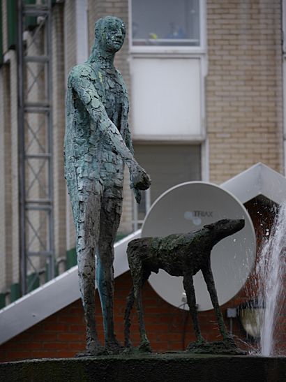 Sculpture of a standing man and a dog