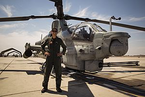 Major Jasmin Moghbeli with an AH-1 Cobra helicopter in July 2017