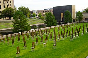 Oklahoma City National Memorial viewed from the south showing the memorial chairs, Gate of Time, Reflecting Pool, and Survivor Tree
