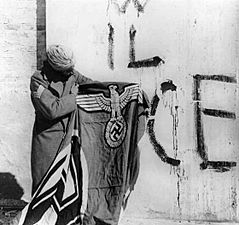 Sikh soldier with captured Swastika flag