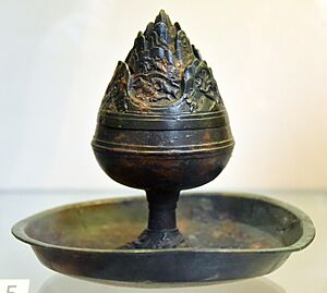 Incense burner, sometimes called a "hill censer" because of its shape (Mountains of Paradise). Bronze. Eastern Han Dynasty, 25-220 CE. From China. Victoria and Albert Museum