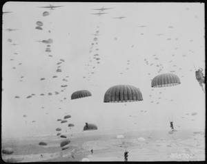 Parachutes open overhead as waves of paratroops land in Holland during operations by the 1st Allied Airborne Army. - NARA - 531392