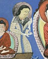 Bamiyan, devotee in caftan, next to the Buddha