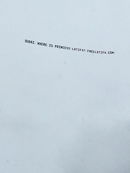 Banner against a cloudy sky, reading: DUBAI, WHERE IS PRINCESS LATIFA? FREELATIFA.COM