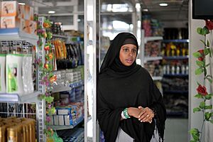 Nasra Agil, owner of Mogadishu's first dollar store, stands among her products in the Somali capital on January 20. AU UN IST PHOTO - Tobin Jones (12085294176).jpg