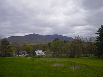 View of the south face of Overlook Mountain in Woodstock, NY with a white house in the foreground