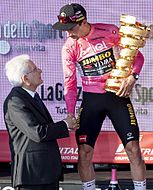 Primož Roglič receives the 2023 Giro d'Italia winner's trophy