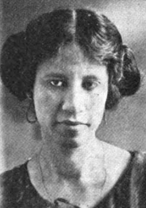 A young African-American woman, with hair parted center and dressed in an updo.