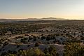 Looking out over the Galisteo Basin at sunset. The Ortiz Mountains and Sandia Mountains are visible in the background
