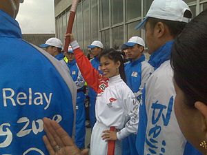 Vanessa Mae holding olympic torch