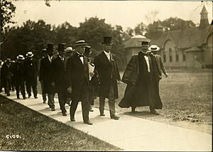Commencement 1912 President Hutchins and dignitaries walking across Diag toward Engineering Arch