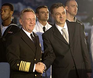 US Navy 061025-N-5330L-235 The President of Montenegro, Filip Vujanovic, and Commander, U.S. Naval Forces Europe Adm. Harry Ulrich III, shake hands during a reception aboard the guided missile cruiser USS Anzio (CG 68)
