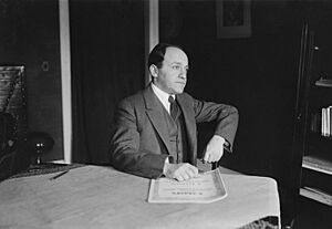 Ernest Bloch in 1917 at a table (retouched)