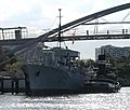 HMAS Diamantina (K-377) berthed under the Goodwill Bridge