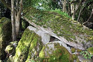 moss covered upright stones support a massive leaning stone roof slab