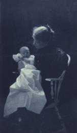Woman sitting in chair holding an infant