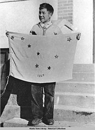 Benny Benson holding the flag of Alaska that he designed.jpg