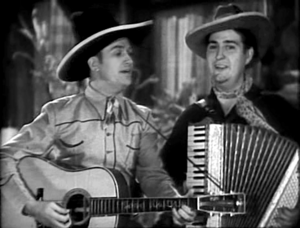 Gene Autry and Smiley Burnette singing in In Old Santa Fe film, 1934