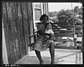 Mrs. Aron Conway and baby swinging on porch of their home in company housing project. Adams, Rowe & Norman Inc.... - NARA - 540599