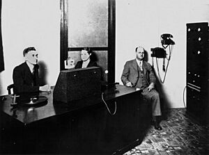 StateLibQld 1 212612 Presenter and guests at 4WK radio station, Warwick, ca.1940