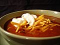 Bowl of chili with sour cream and cheese