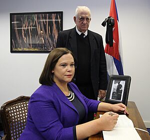 Mary Lou McDonald with Dr Hermes Herrera Hernández signing the book of condolence to Fidel Castro at the Cuban Embassy in Dublin (30489680553)