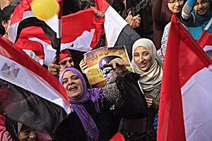 Participants holding flags and pictures of Abdel Fateh el Sissi