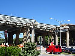 An elevated roadway being widened, seen from the ground