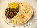 A thali with daal roti bhindi ki sabzi and mango pickle