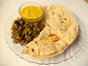 A thali with daal roti bhindi ki sabzi and mango pickle