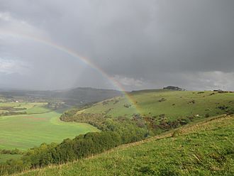 Devil's Dyke with storm clouds and rainbow