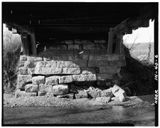 General view beneath structure, showing arch rings and lower chords on stone abutment. - Leatherwood Station Covered Bridge, Spanning Leatherwood Creek (moved to Billie Creek HAER IND,61-MONT,1-6