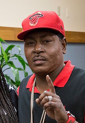 Headshot of Trick Daddy in a red baseball hat and a red-accented black jacket