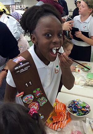 Camp Zama Girls Scout member eats sushi and rice
